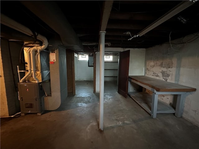 basement with electric panel and heating unit