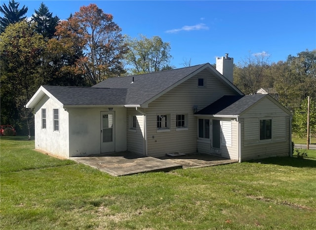 rear view of property with a lawn and a patio