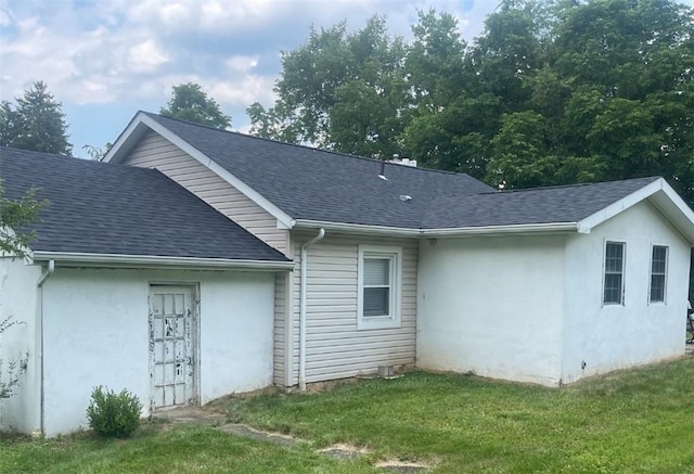 3036 Mcneal Rd, Hampton, PA 15101 - view of side of property with a shingled roof, stucco siding, and a lawn