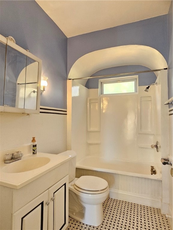 full bathroom featuring toilet, vanity, tile patterned floors, and  shower combination