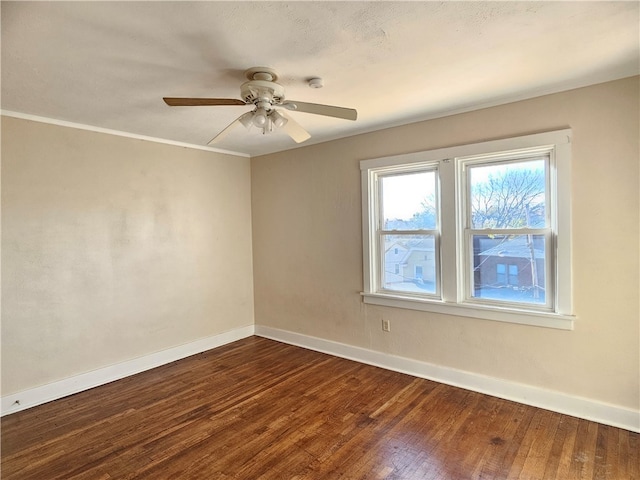 unfurnished room featuring ceiling fan, dark hardwood / wood-style flooring, and ornamental molding