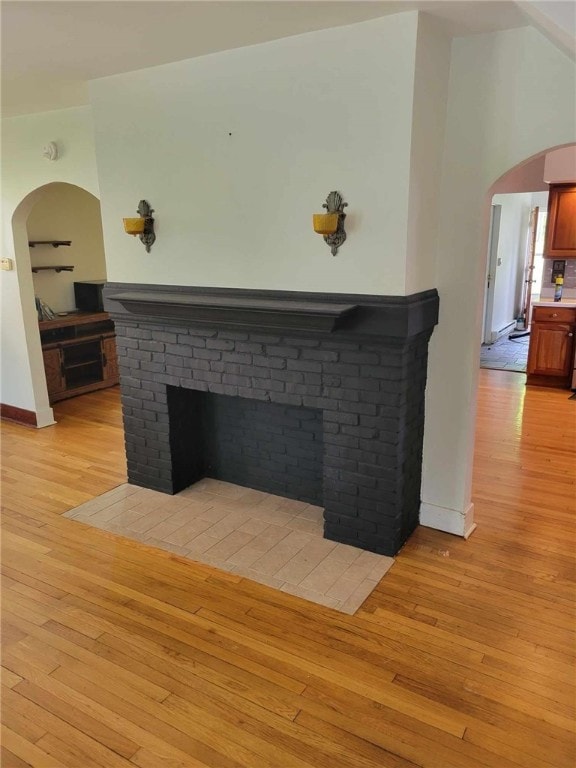 interior details featuring hardwood / wood-style floors and a brick fireplace