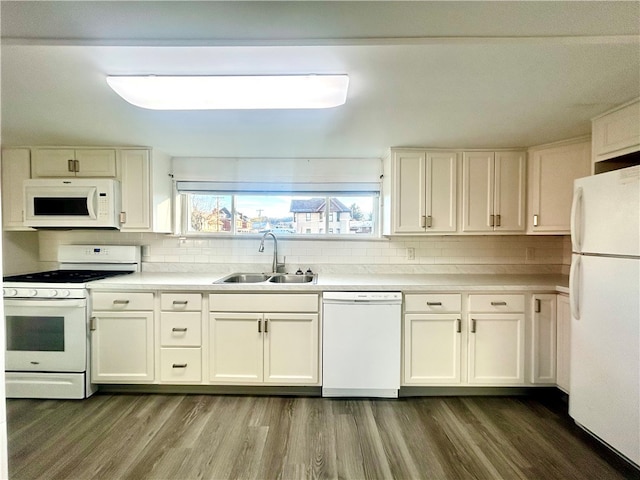 kitchen featuring wood-type flooring, white cabinetry, backsplash, sink, and white appliances