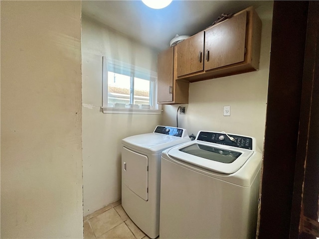 laundry area featuring cabinets, separate washer and dryer, and light tile patterned floors