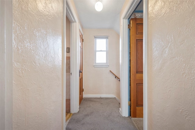 hallway with light colored carpet