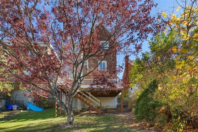 exterior space featuring a lawn and a wooden deck