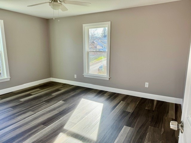 unfurnished room with dark hardwood / wood-style flooring and ceiling fan