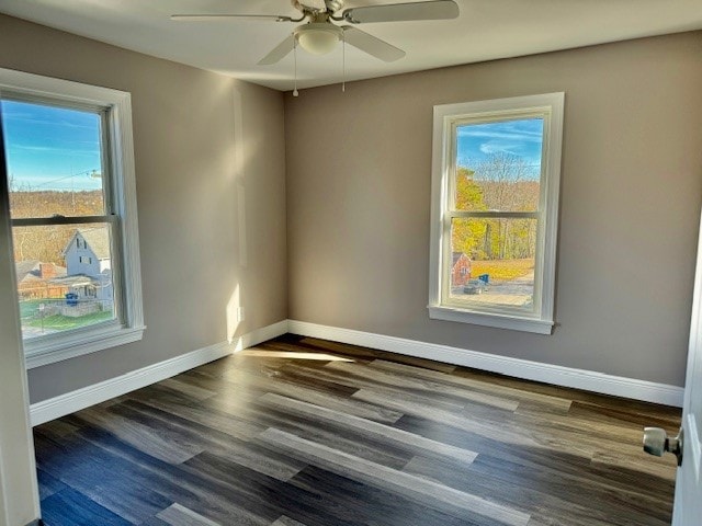 empty room featuring ceiling fan and dark hardwood / wood-style floors