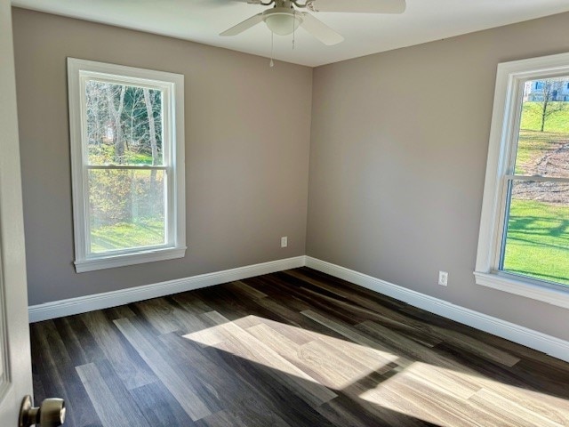 unfurnished room with dark wood-type flooring, ceiling fan, and plenty of natural light