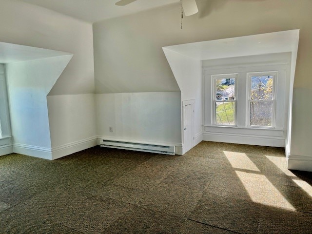 bonus room with vaulted ceiling, ceiling fan, a baseboard heating unit, and carpet floors