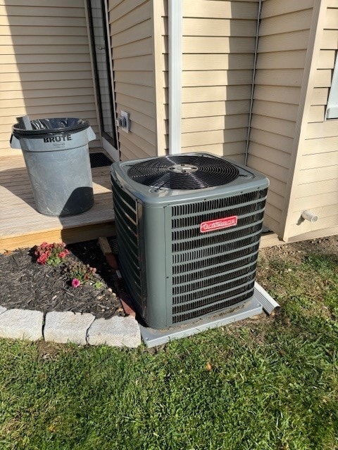 exterior details with wood walls and central AC unit