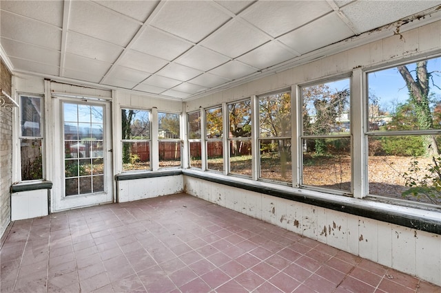 unfurnished sunroom featuring a paneled ceiling