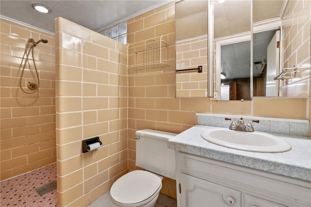 bathroom with tile walls, tiled shower, toilet, and vanity