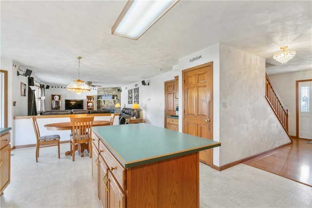 kitchen featuring hanging light fixtures, a kitchen island, and an inviting chandelier