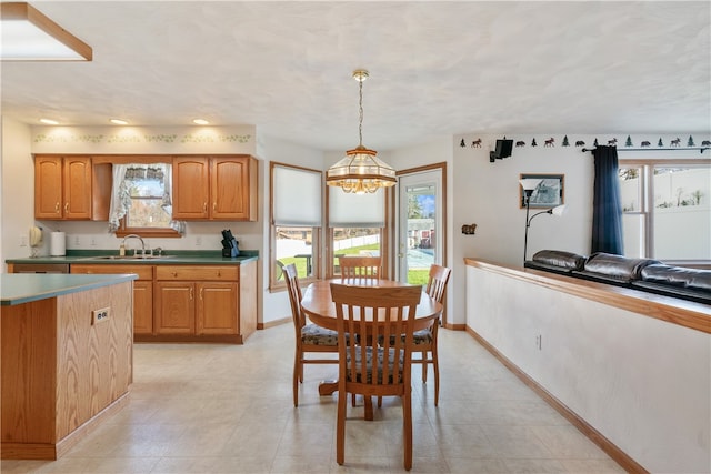 tiled dining area with an inviting chandelier and sink