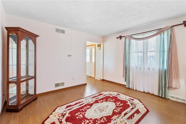 unfurnished room with wood-type flooring