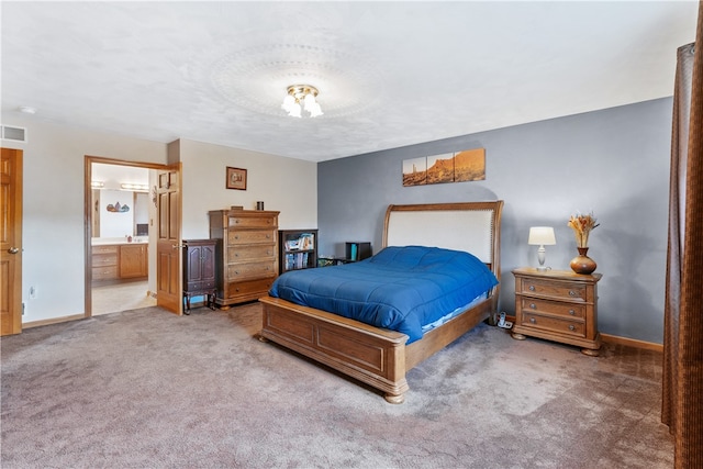 carpeted bedroom featuring connected bathroom