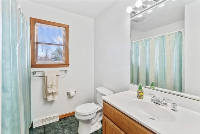 bathroom with tile patterned flooring, vanity, and toilet