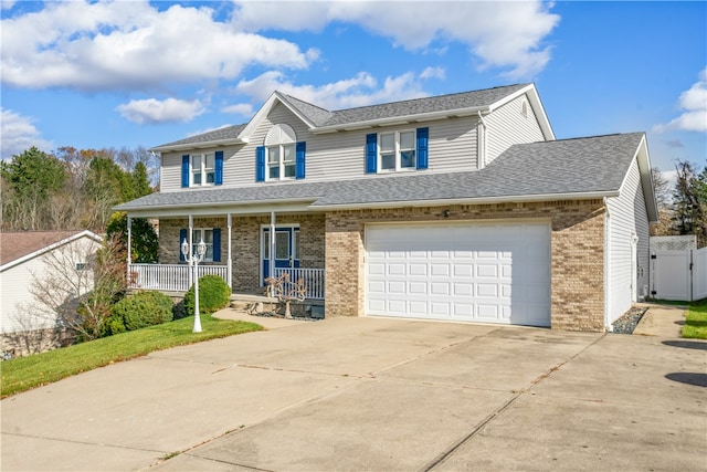 view of front of house featuring a porch and a garage