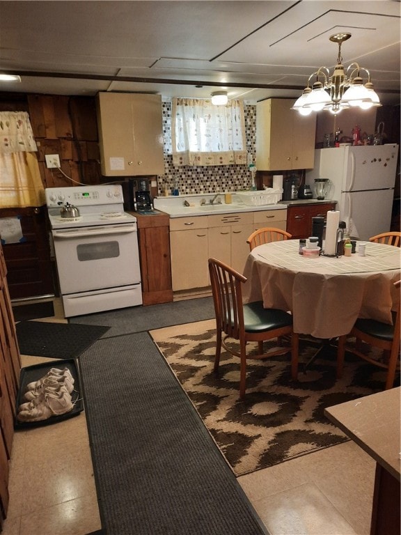 kitchen featuring decorative backsplash, white appliances, decorative light fixtures, and cream cabinets