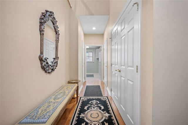 hall with hardwood / wood-style floors