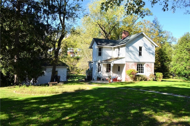 back of property featuring a yard