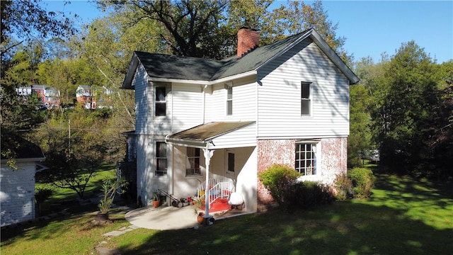 rear view of house with a lawn