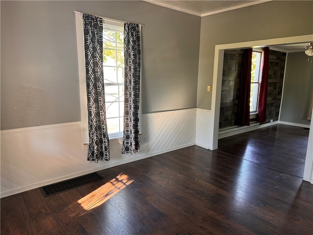 spare room featuring ceiling fan, dark hardwood / wood-style floors, and ornamental molding