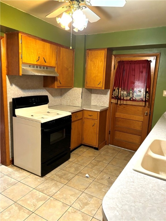 kitchen featuring sink, tasteful backsplash, light tile patterned floors, ceiling fan, and white electric stove