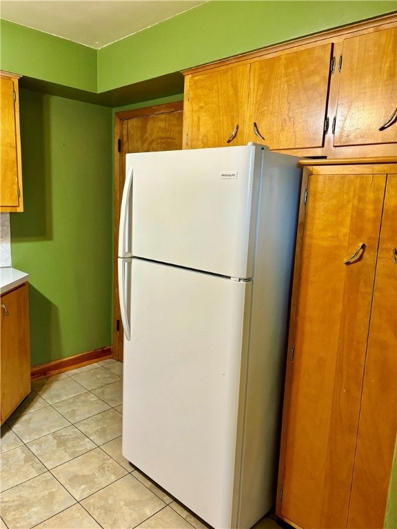 kitchen featuring light tile patterned floors and white fridge