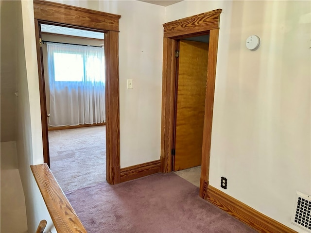 hallway with light colored carpet