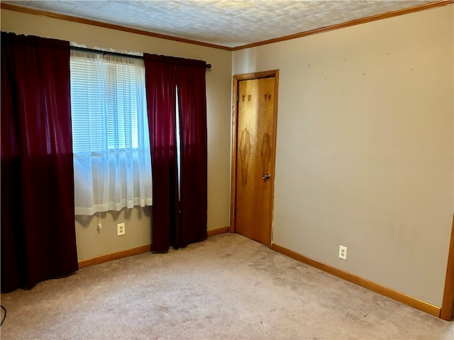 carpeted spare room featuring a textured ceiling and ornamental molding