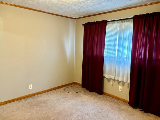 carpeted empty room featuring crown molding