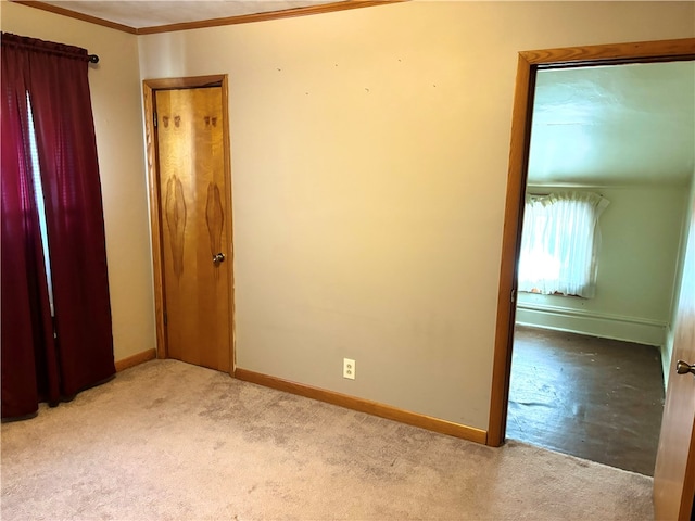 unfurnished bedroom with ornamental molding and light colored carpet