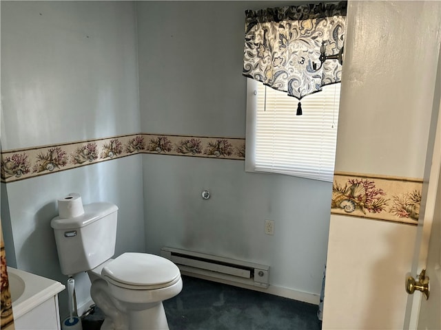 bathroom with a baseboard radiator, vanity, and toilet