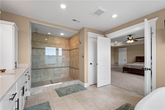 bathroom featuring a tile shower, vanity, tile patterned floors, and ceiling fan