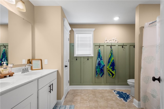 bathroom featuring tile patterned floors, vanity, and toilet