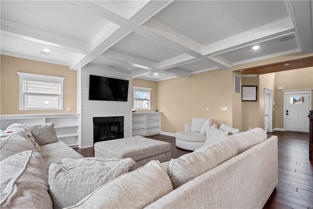 living room featuring dark wood-type flooring, coffered ceiling, ornamental molding, a fireplace, and beam ceiling