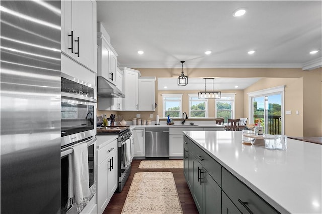 kitchen with white cabinets, gray cabinetry, hanging light fixtures, and appliances with stainless steel finishes