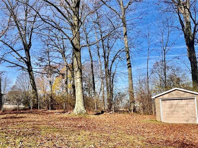 view of yard with an outbuilding and a garage