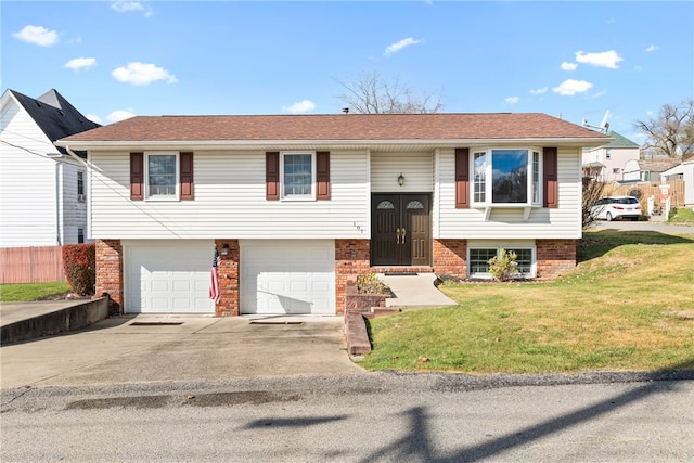 bi-level home featuring a garage and a front yard