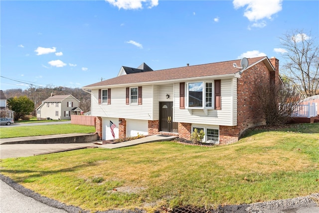 bi-level home with a front lawn and a garage