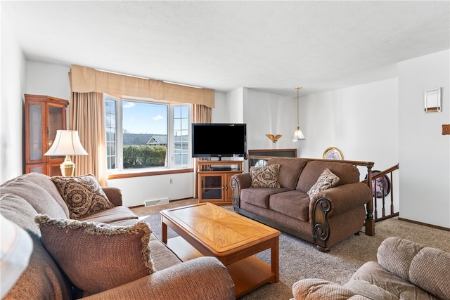 carpeted living room featuring a textured ceiling