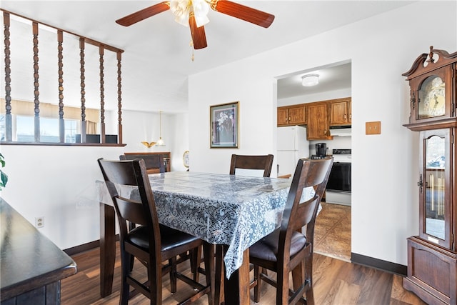 dining room with ceiling fan and dark hardwood / wood-style floors