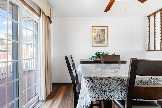 dining room with ceiling fan and dark hardwood / wood-style flooring