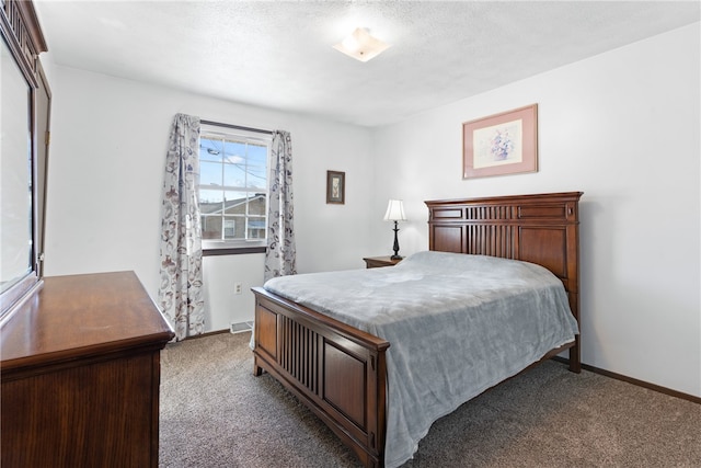 bedroom featuring a textured ceiling and carpet flooring