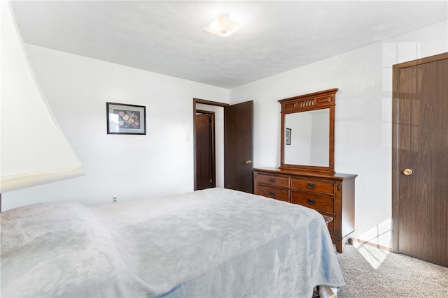 carpeted bedroom featuring a textured ceiling