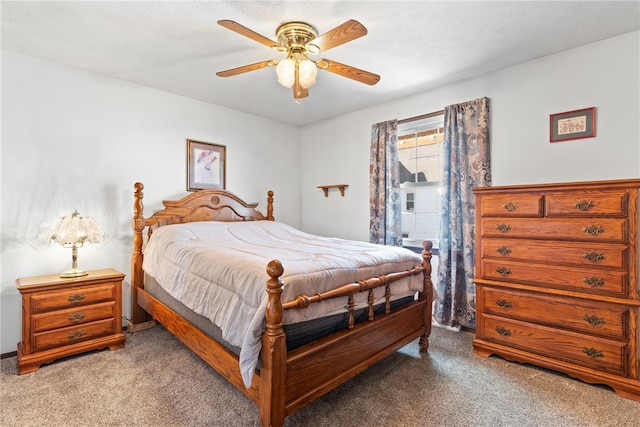 carpeted bedroom featuring a textured ceiling and ceiling fan