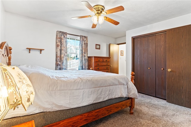 carpeted bedroom featuring a closet, a textured ceiling, and ceiling fan