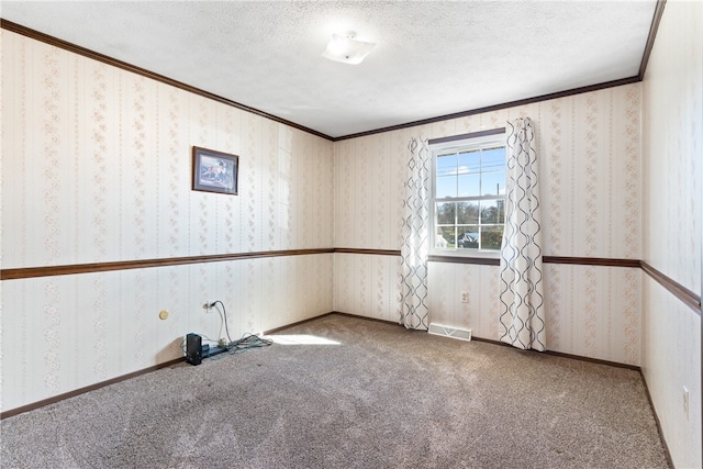 carpeted empty room with a textured ceiling and crown molding